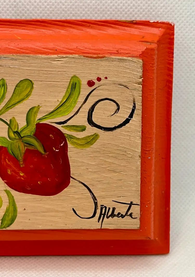 Tole painting featuring strawberries and daisies on a wooden plaque signed
