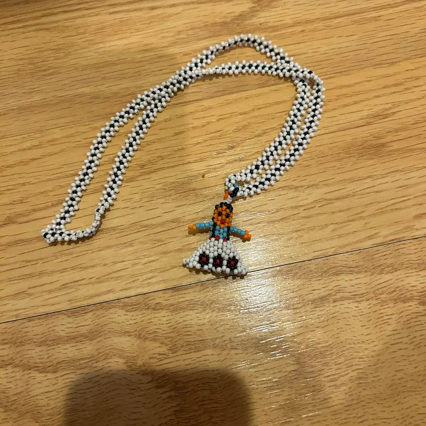 Seed Bead Necklace With A Little Girl On The End