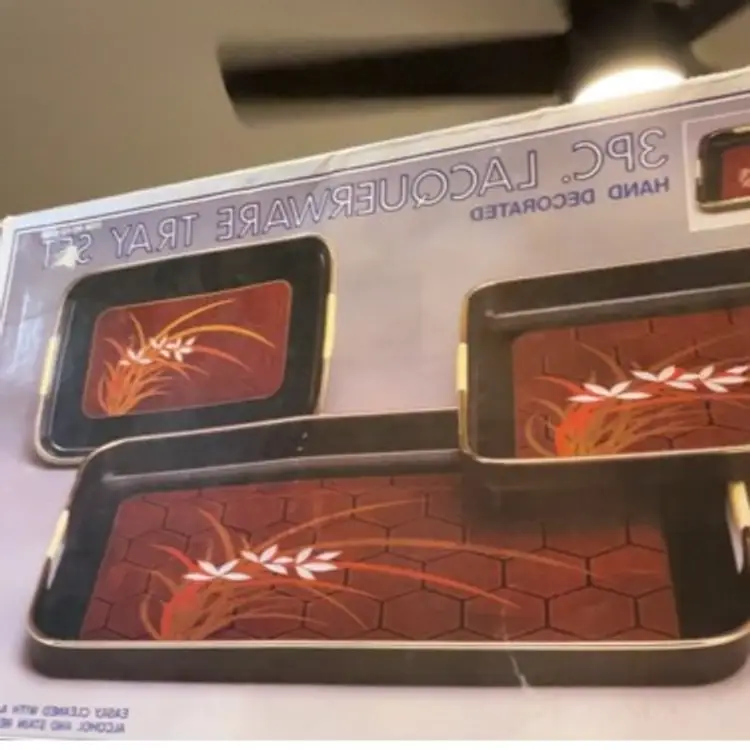 3 Piece Lacquer Ware Tray Set. Made In Japan. Tray Has Rubber Like Substance On Handles Which Looks Like Straw. Measurements Are 18 3/4”x11”, 10 5/8”x10 5/8”, 10 5/8”x7”. Has Box It Came In Looks Like Never Used.