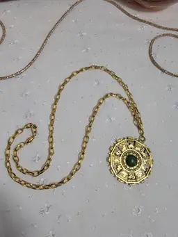 Vintage 1970s Chinese zodiac goldtone pendant and necklace with green with glitter resin center