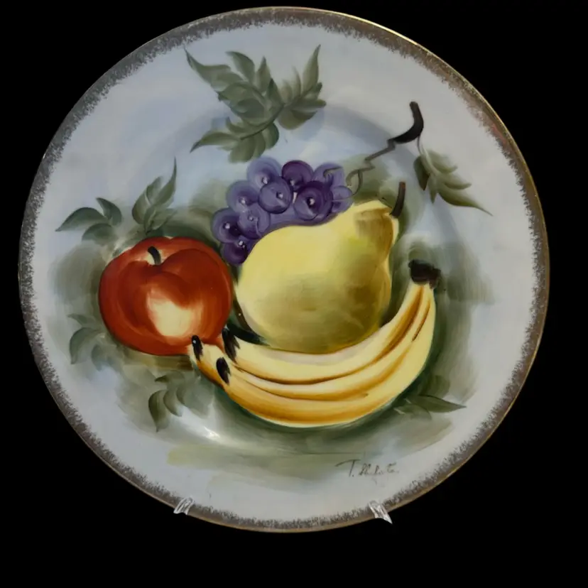 Norleans decorative plate featuring fruit, signed by T. Shibata.