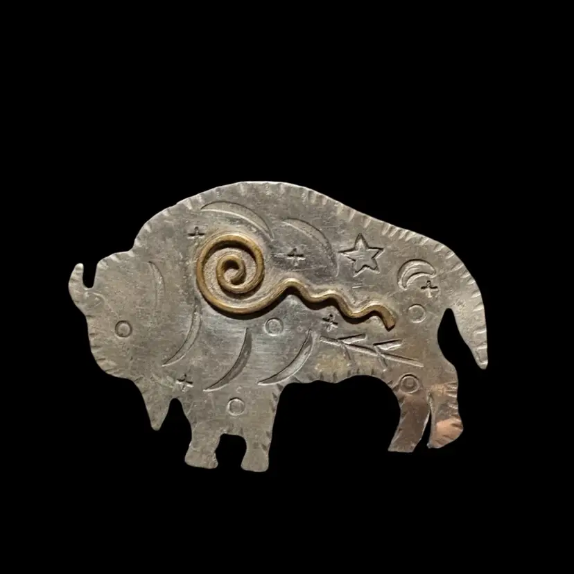 Handcrafted silver pendant with celestial motifs and gold spiral.