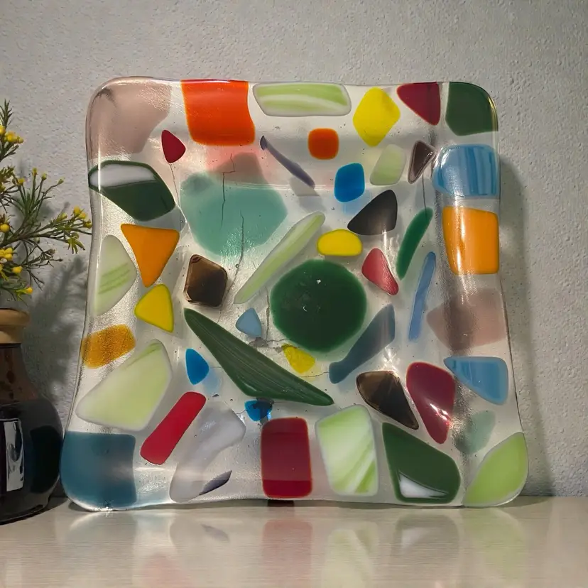 This is a handmade multicolored fused glass dish with a "crazy paving" design