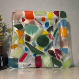 This is a handmade multicolored fused glass dish with a "crazy paving" design