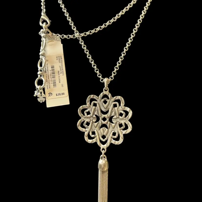 A silver-tone Lucky Brand floral tassel pendant necklace. 30” Chain, 4” Pendant New With Tags.
