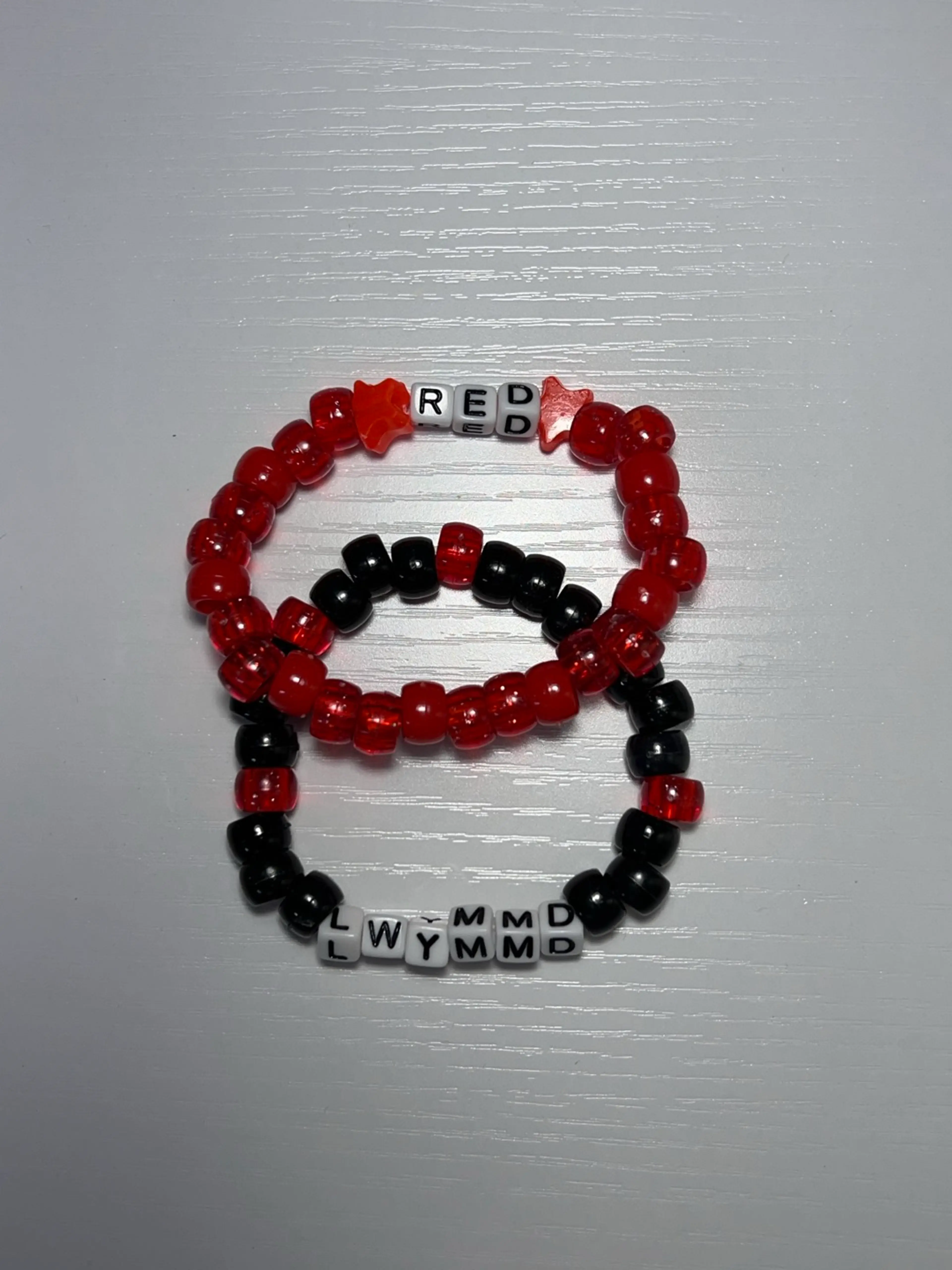 “Red” And “LWYMMD” Friendship Bracelets