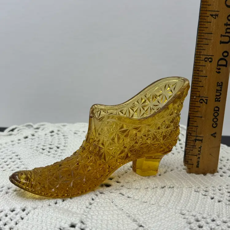 Vintage amber glass slipper with Daisy and Button pattern.