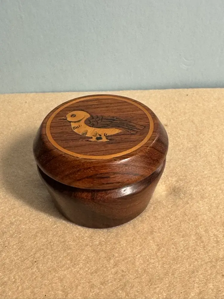Decorative round Marquetry featuring a stylized bird.