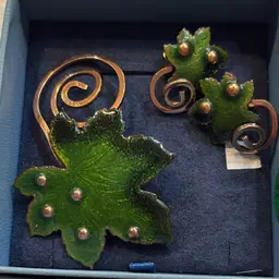 This is a vintage 1950s Matisse Renoir green enamel on copper maple leaf brooch and matching clip-on earrings set.