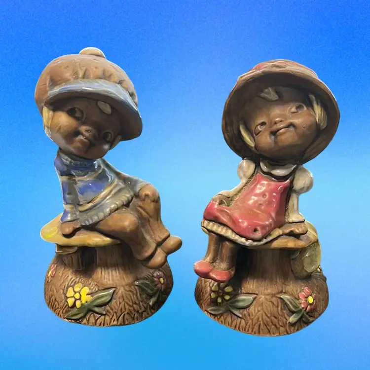 Pair of vintage ceramic figurines depicting a boy and a girl on toadstools/ Mushrooms. Signed. 5.5”tall