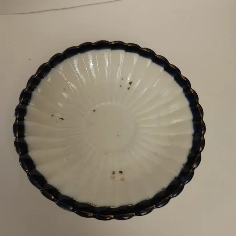 Antique German porcelain saucer. Cream with blue trim. No chips. 4.5 in diameter.