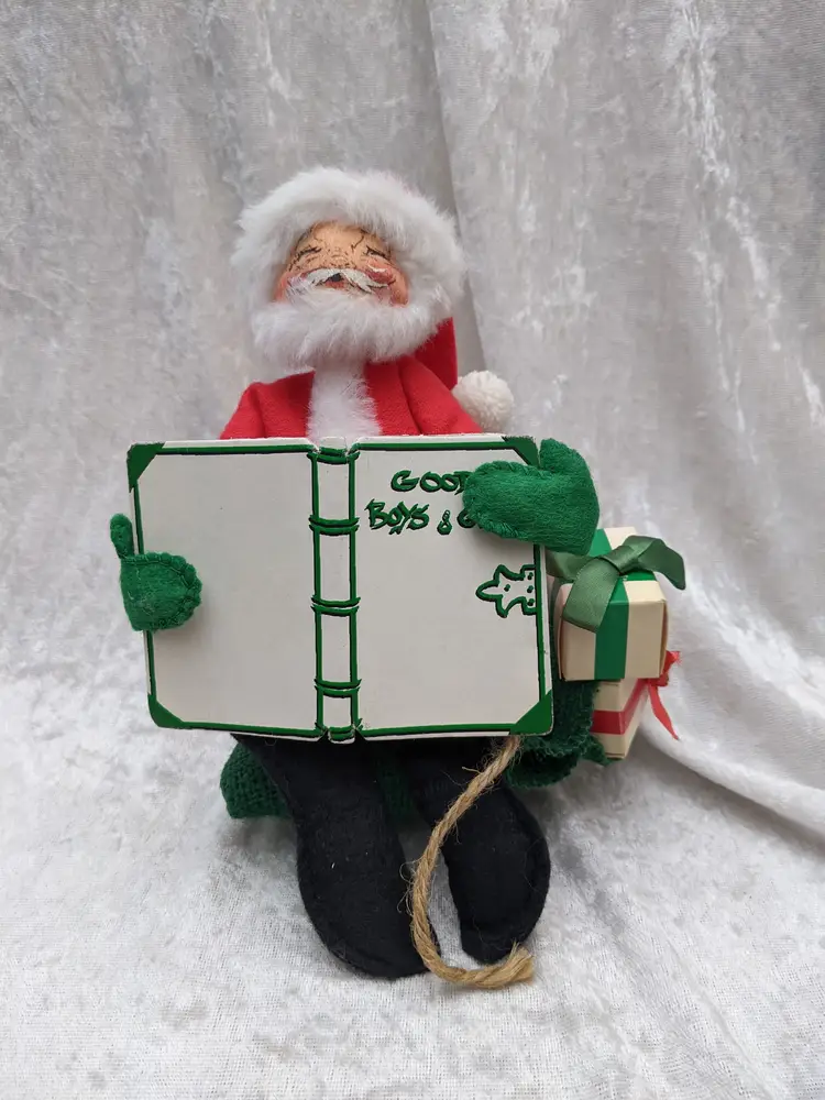 VTG Annalee 8" Santa Mobilitee Doll sitting on his bag Bag with  Presents reading a book of Good Boys Girls Christmas decor . He is 7in wide and 8 in tallVery good  condition Clean with no damage. no weird smells. Please check the photos for details. Comes from a smoke free home. We do have pets.