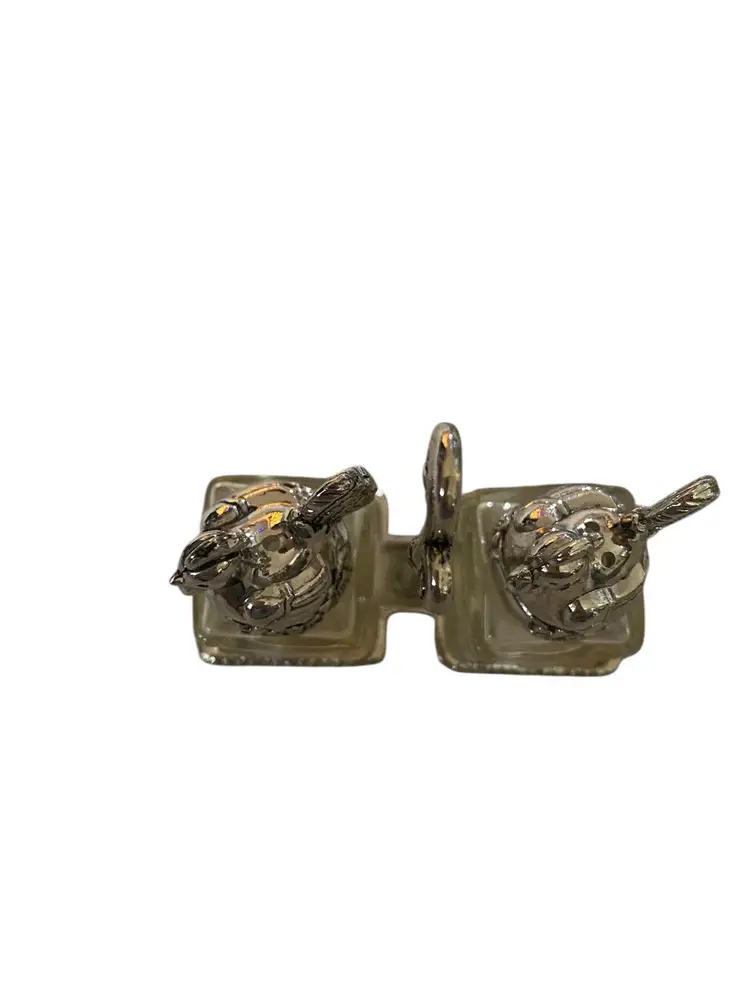 This is a Thomas Leiblein (or Godinger) silver-plated and crystal chicken salt and pepper shaker set with a carrier, possibly part of the "Fox in the Henhouse" collection