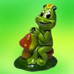 Vintage Lefton ceramic Frog Sitting On A Mushroom & Knitting.
Such A Colorful Figurine.