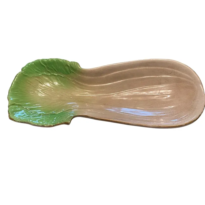 This item is a vintage ceramic celery dish, often styled in the majolica tradition with a hand-painted green glaze and embossed detailing to resemble a celery stalk