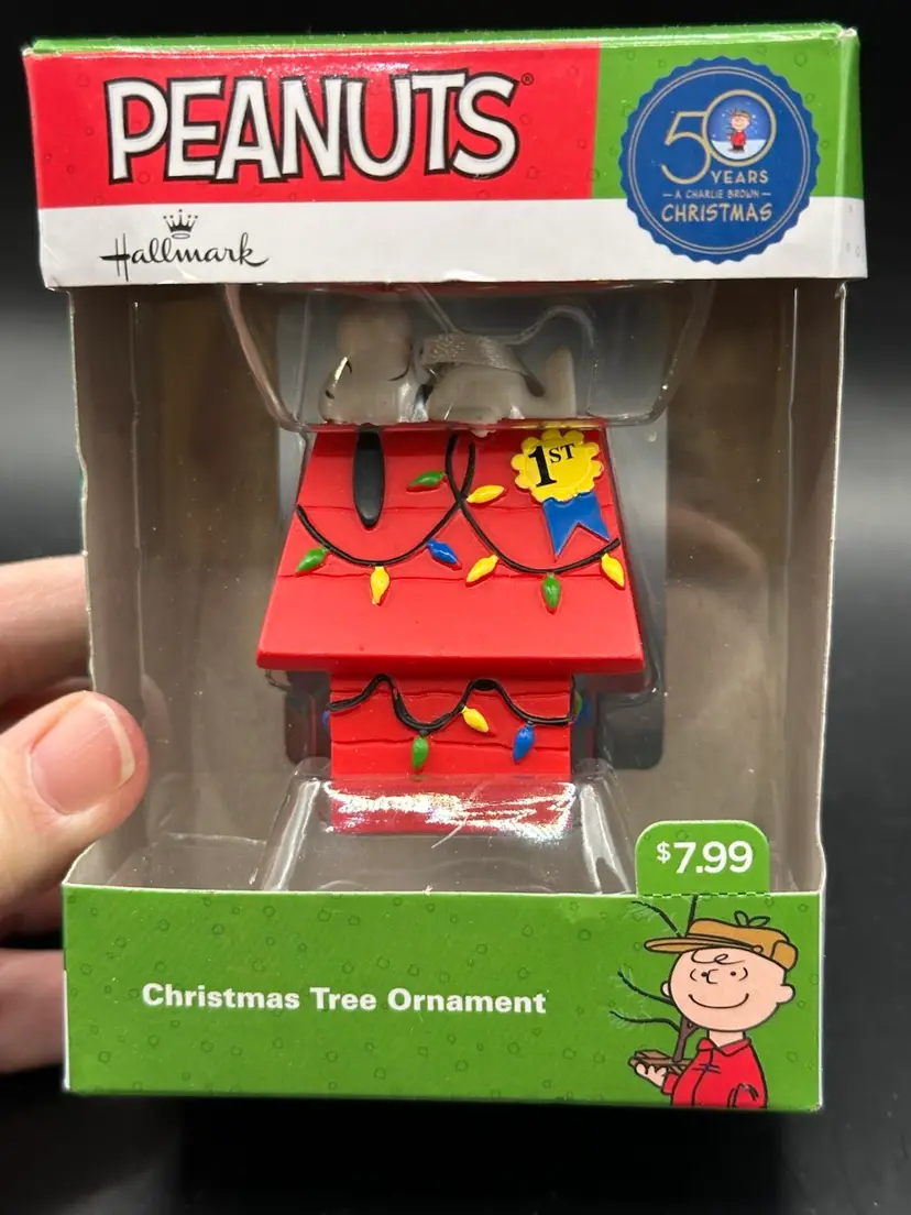 50th anniversary of the beloved PEANUTS comic strip with the Hallmark SNOOPY DOG HOUSE Ornament