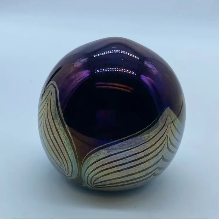 #0050 Iridescent art glass paperweight with swirling decorative elements.