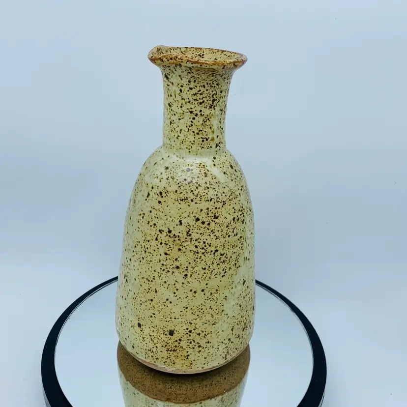 #2211 Guy de Pelteau studio pottery carafe with a speckled glaze and leaf design Signed