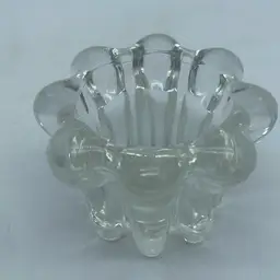 #0819 Clear glass fluted rim candle holder with multiple small feet.
