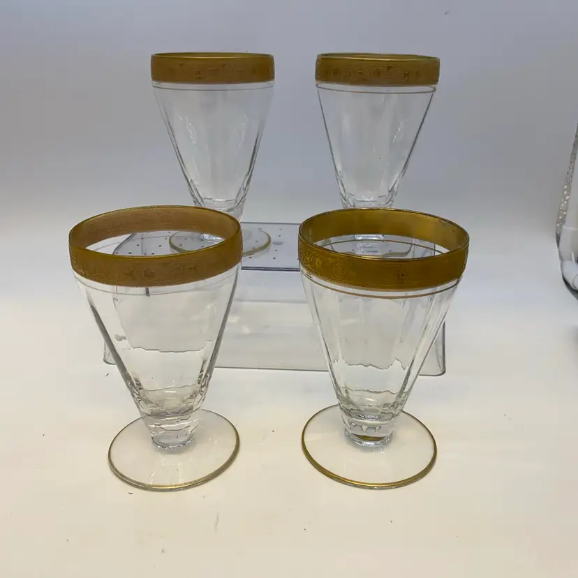 #1317 Set of four Tiffin-Franciscan footed tumblers with gold rim decoration.