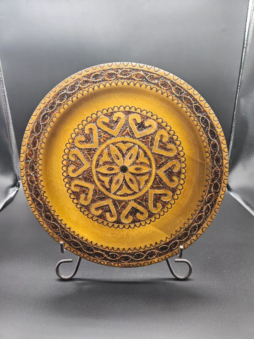 This vintage hand-turned carved wood art plate from Poland is a unique piece of folk art that showcases the intricate craftsmanship and artistic flair of Polish artisans. Measuring 11 inches in diameter, this handmade plate features detailed carving and smoothing, making it a charming addition to any collection of European cultures and ethnicities.  It is pre-owned and has been very gently used. There is little to no wear/  PLEASE review the images carefully and feel free to reach out if you have any questions or would like any other pictures!  Be aware that most of our items are vintage or antique and may have small defects or signs of age. We do our best to provide the best items possible. Also, we do light cleaning on all our items. If we find any defects, we do our best to identify them in the description.   If there is an issue with your purchase for any reason, please reach out to us and we will be happy to take care of it for you.  Also, we would love it if you would Follow, Like and/or Share, our items and/or our store page!