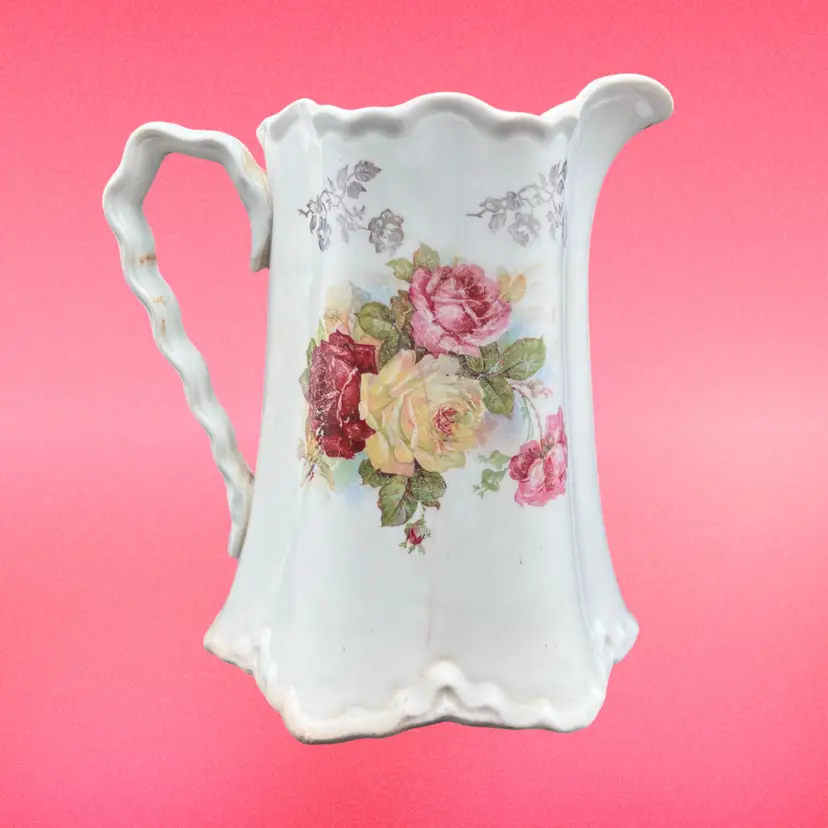 #153B As Is. Antique CP Co Porcelain Pitcher With Floral Decorations Ornate Rim And Handle. Staining And Some Old Age Cracks Show Her Character.