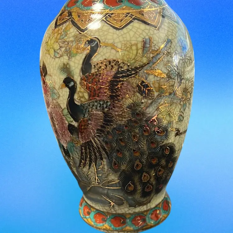 This is a Satsuma-style vase with peacock and floral decorations. 8” Tall Oriental With Gold Accent