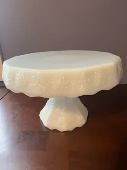 Vintage Anchor Hocking milk glass cake stand with embossed grape and vine pattern. 6.5” Tall By 10” Wide