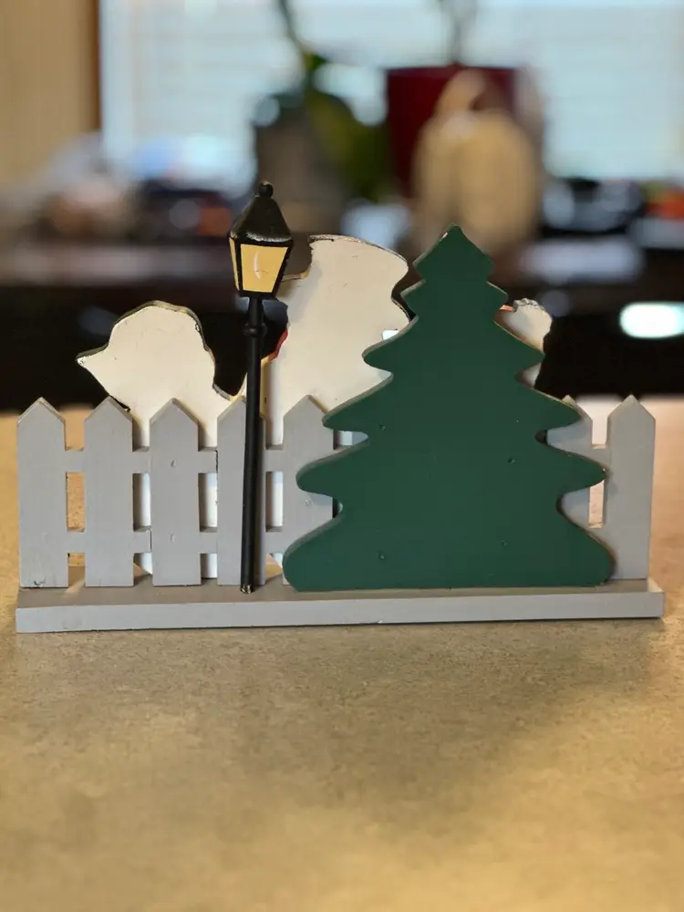 Wooden Christmas decoration featuring caroling snowmen figurines