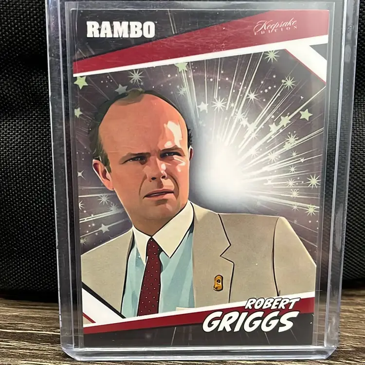 2024 Keepsake Collection Robert Griggs parallel trading card, Rambo franchise. Features an illustrated portrait of the character Robert Griggs, who appeared in the movie Rambo III.