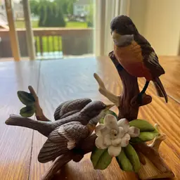 Royal Crown. Jonathan Byron bisque porcelain figurine of two robins on a branch. 8x8”