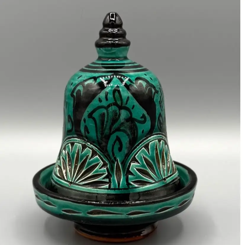 Signed Hand-painted Mexican ceramic bell with floral motifs and a dark green glaze.