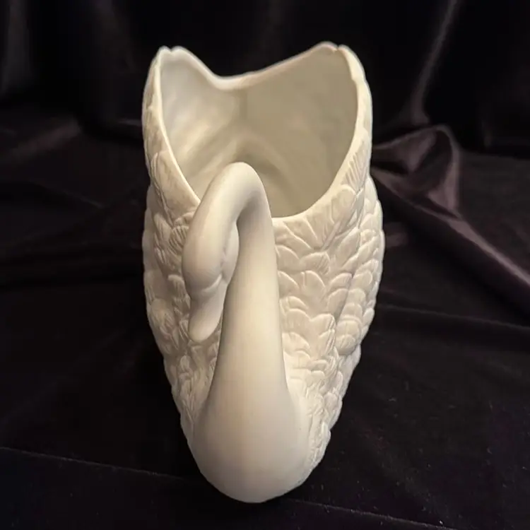 Beautiful vintage porcelain swan planter, stamped "F.T.D.A." on the bottom. 
It is crafted with a matte bisque finish and intricate feather details