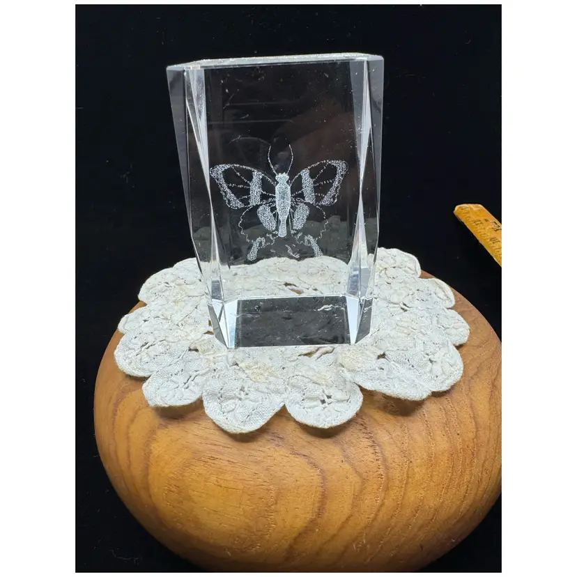 A laser-etched glass cube paperweight featuring a butterfly.