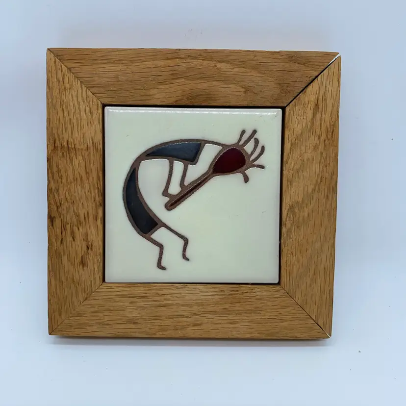 #3048 Framed ceramic tile featuring a stylized Kokopelli figure.