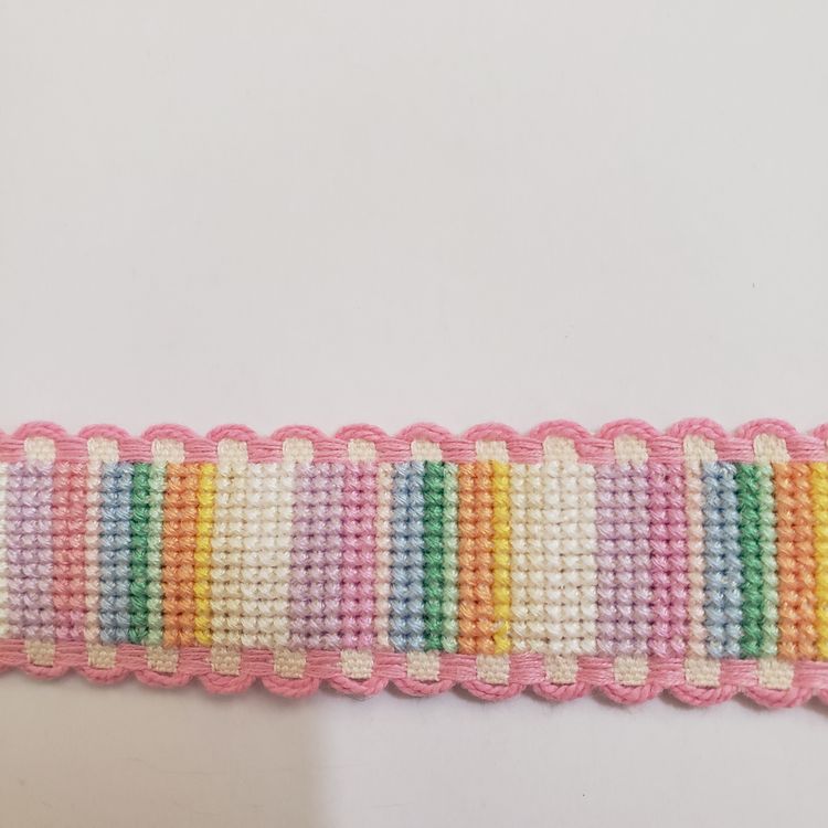 New Cross-stitched multi colored striped Ribband with pink trim.