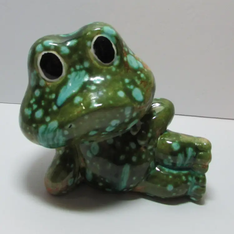 vintage ceramic Neil the Frog laying figurine green with blue speckles