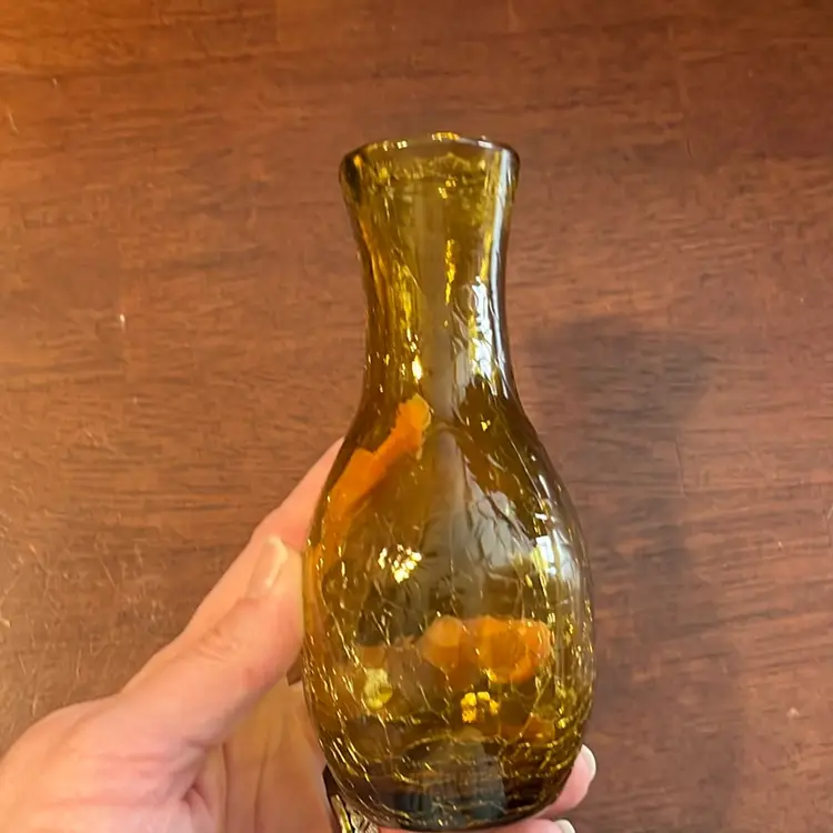 Amber crackle glass vase with a narrow neck and flared rim. 5.5”
