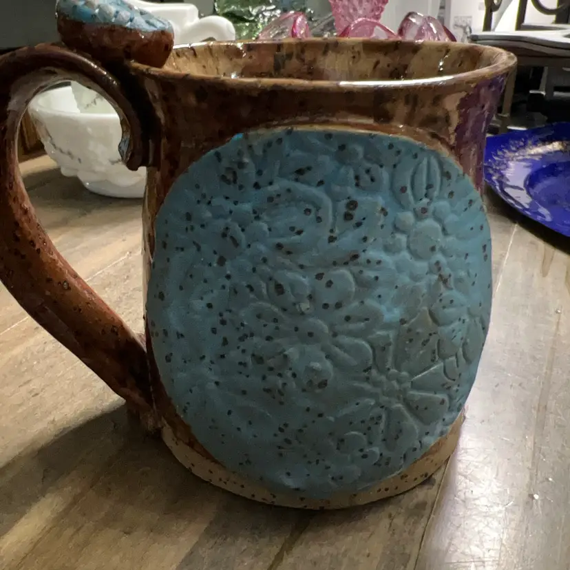Handmade studio pottery mug with textured blue appliqué.DMPottery?  Tiny Chip On Underside Base