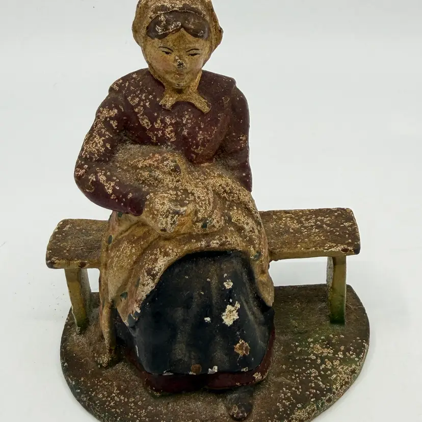 Vintage Cast Iron Amish Woman Sitting on Bench Doorstop