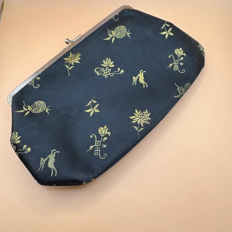 black and gold embroidered silk evening clutch bag with a metal kiss-lock clasp