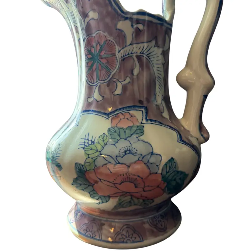 Vintage hand-painted ceramic pitcher with Asian floral motifs. 11.5”