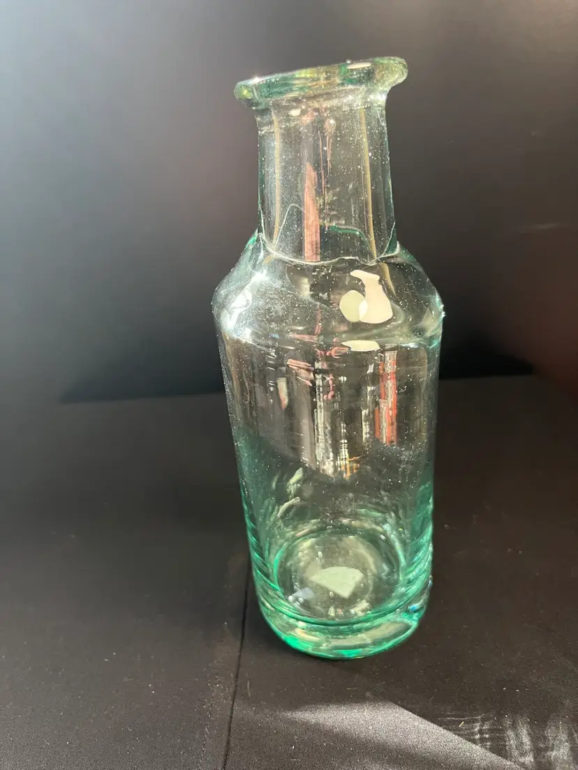 Light Green Glass Blown Bottle, very Smooth Pontil. Interesting Glass "Overlay". Glows on the thicker areas of glass a light Orange. Lot 39