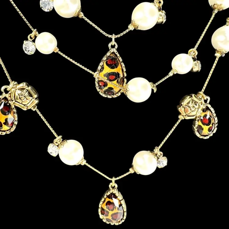 BETSEY JOHNSON Signed Triple Tiered Gold-tone Necklace. Faux Pearls & Diamonds with Leopard Print Teardrop Beads and Gold-tone Floral Charms.