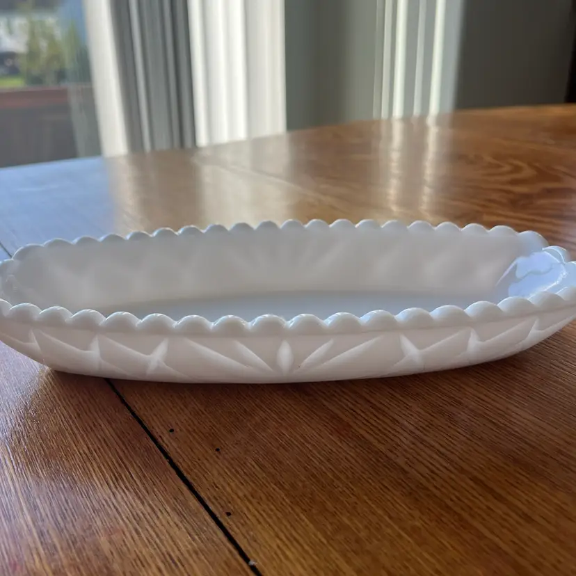 Vintage oval milk glass relish dish with pressed starburst and diamond pattern. 9.5”x4.5”