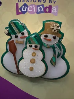 Designs By Lucinda ~ Vintage SNOWMAN FAMILY Pin / Brooch  ~ Green Background ~ The Kid Is Glittery ~ Each Snowman Has Accessories In Shades Of Green, Silver And Gold. Brrrr! ❄️☃️