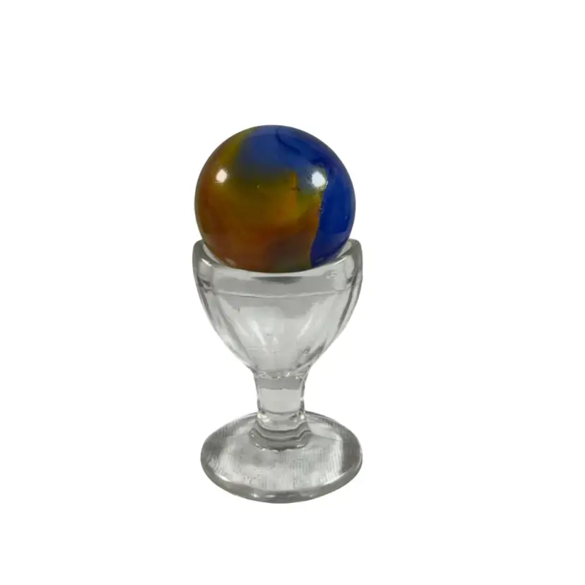 Vintage 1.5” Valor Blue with Yellow & Red Swirl Art Glass Marble on a Glass Eye Wash Cup