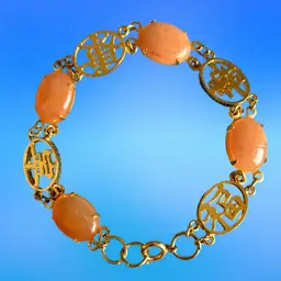 Vintage Peach  Oval Cabochons And Gold Tone Medallions Bracelet.