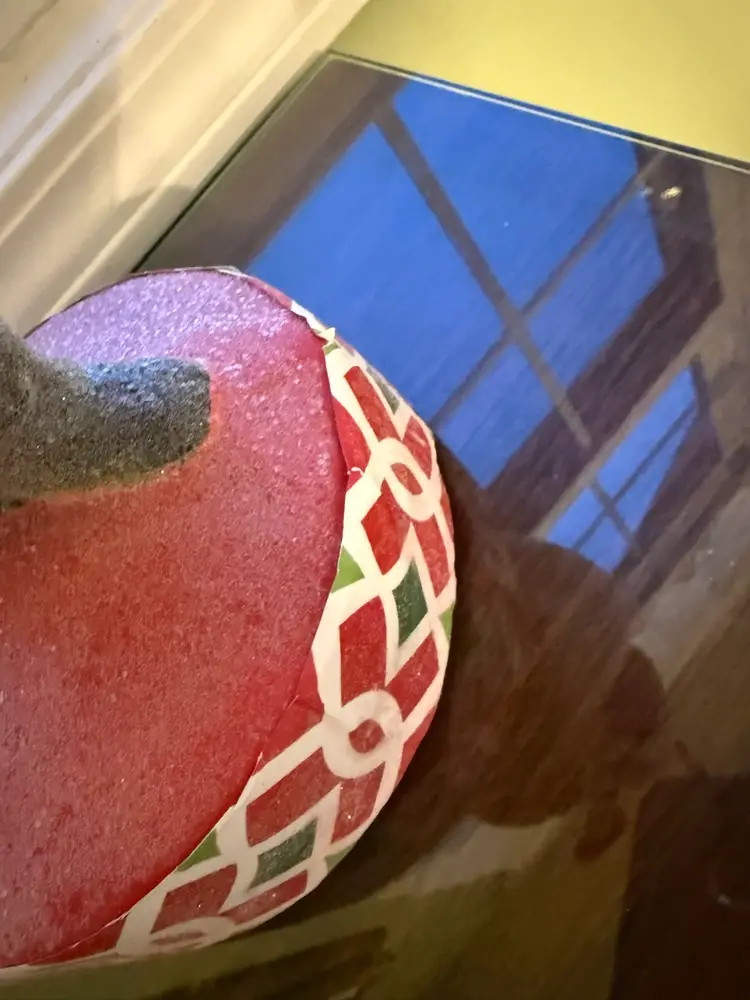 vintage Santa/St. Nick figurine holding candy, canes & ornament; resin/colorful