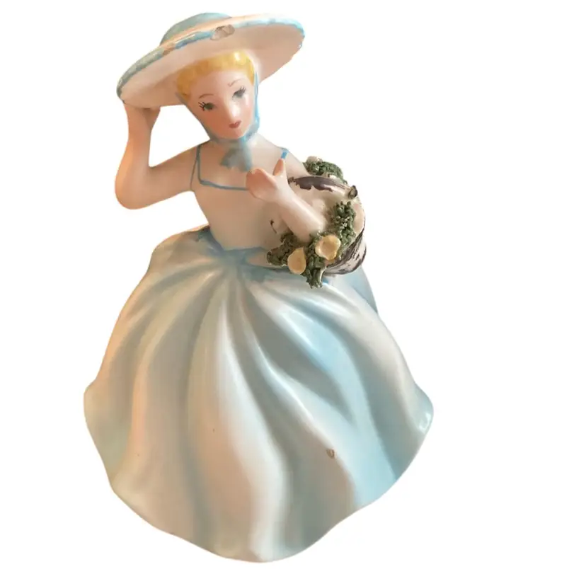 Lady Figurine Holding Flowers Made Into A Hat Pin Holder.